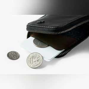 Bellroy Card Pocket wallet in Black, close-up with coins and a card - The Simple Man
