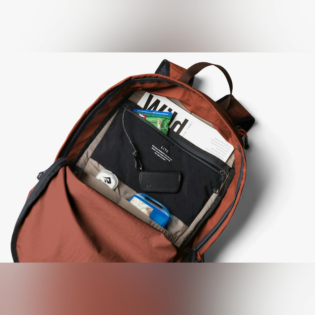 Bellroy Lite Daypack in Clay, open front pocket with organizer contents - The Simple Man