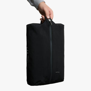 Bellroy Lite Packing Caddy 10L in Black, held by the handle, upright - The Simple Man