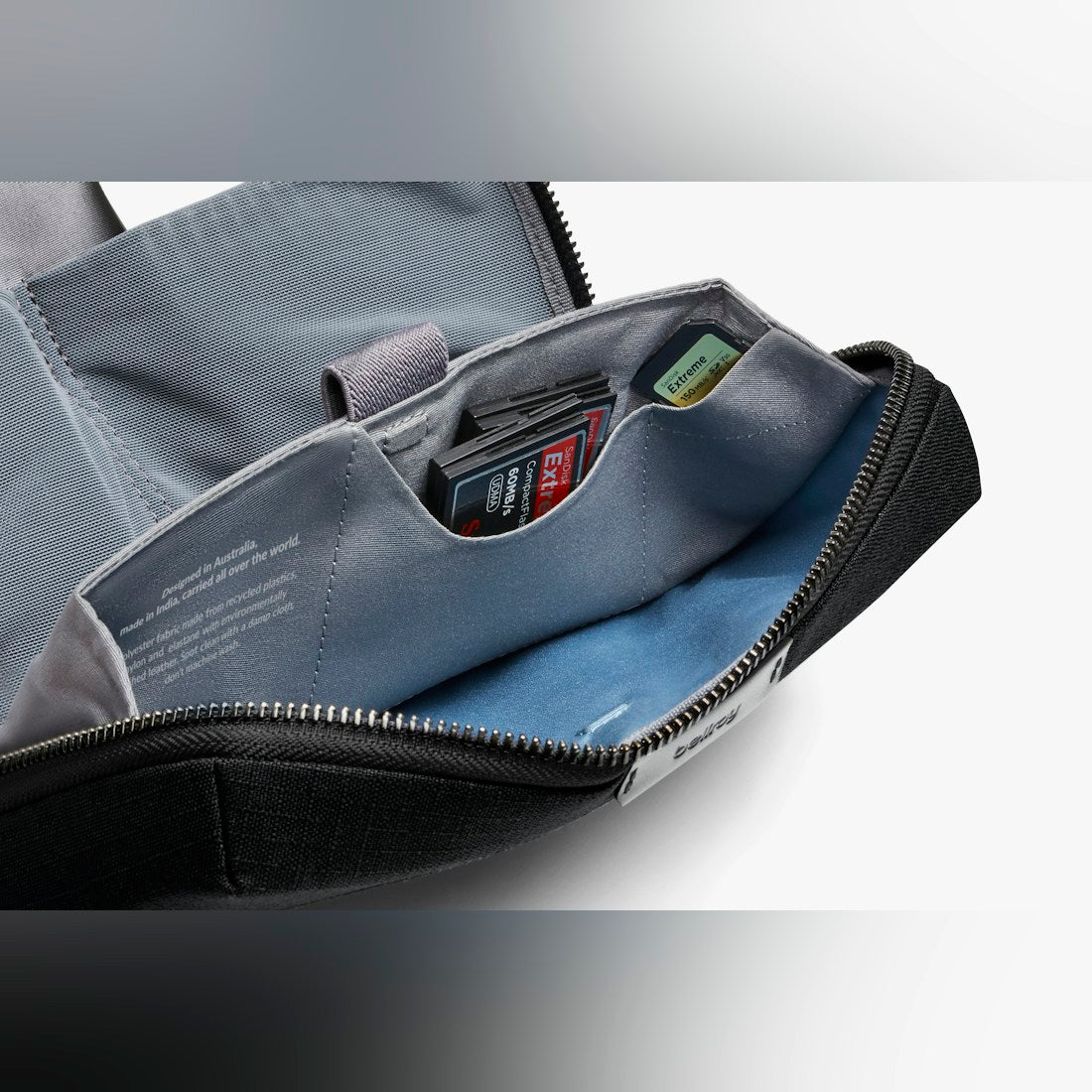 Bellroy Tech Kit cable organizer in Black, close-up of open interior pockets with blue lining - The Simple Man