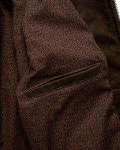 Inside of the brown cowhide trucker jacket showing the vintage mini print cotton lining and inside pocket - The Simple Man