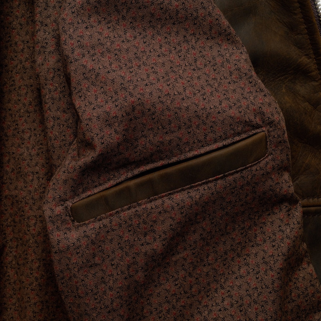 Inside of the brown cowhide trucker jacket showing the vintage mini print cotton lining and inside pocket - The Simple Man