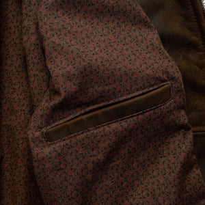 Inside of the brown cowhide trucker jacket showing the vintage mini print cotton lining and inside pocket - The Simple Man