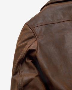 Close-up of the shoulder and sleeve of the brown cowhide trucker jacket showing the pull-up leather finish - The Simple Man