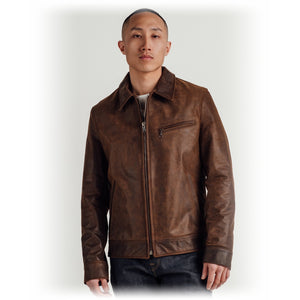 Man wearing the brown cowhide trucker jacket zipped, front view on model - The Simple Man
