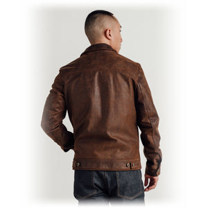 Back view on model of the brown cowhide trucker jacket with adjustable side tabs - The Simple Man