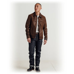 Full length view of a man wearing the brown cowhide trucker jacket with dark jeans and boots - The Simple Man
