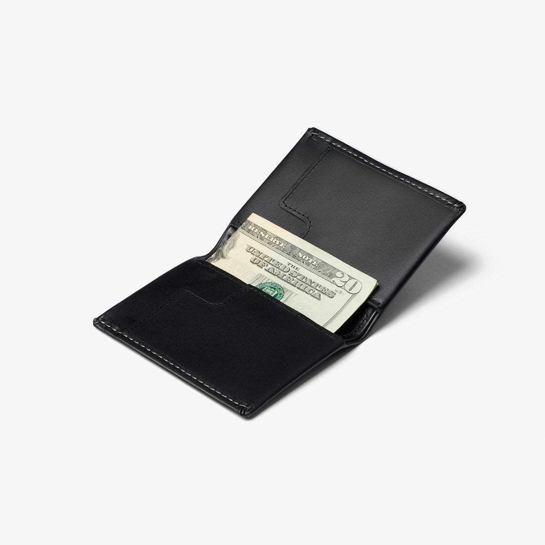 Bellroy Slim Sleeve wallet in Black, open with folded cash in the bill slot - The Simple Man