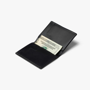 Bellroy Slim Sleeve wallet in Black, open with folded cash in the bill slot - The Simple Man