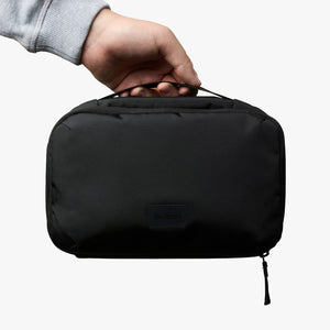 Bellroy Hanging Toiletry Kit in Black, held in a hand, front view - The Simple Man