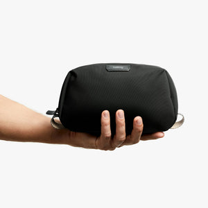 Bellroy Toiletry Kit in Black, held in a hand to show size - The Simple Man