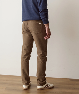 Man wearing 5 Pocket Flex Terry Pant Athletic Fit in Daisy Brown from behind, styled with sneakers - The Simple Man