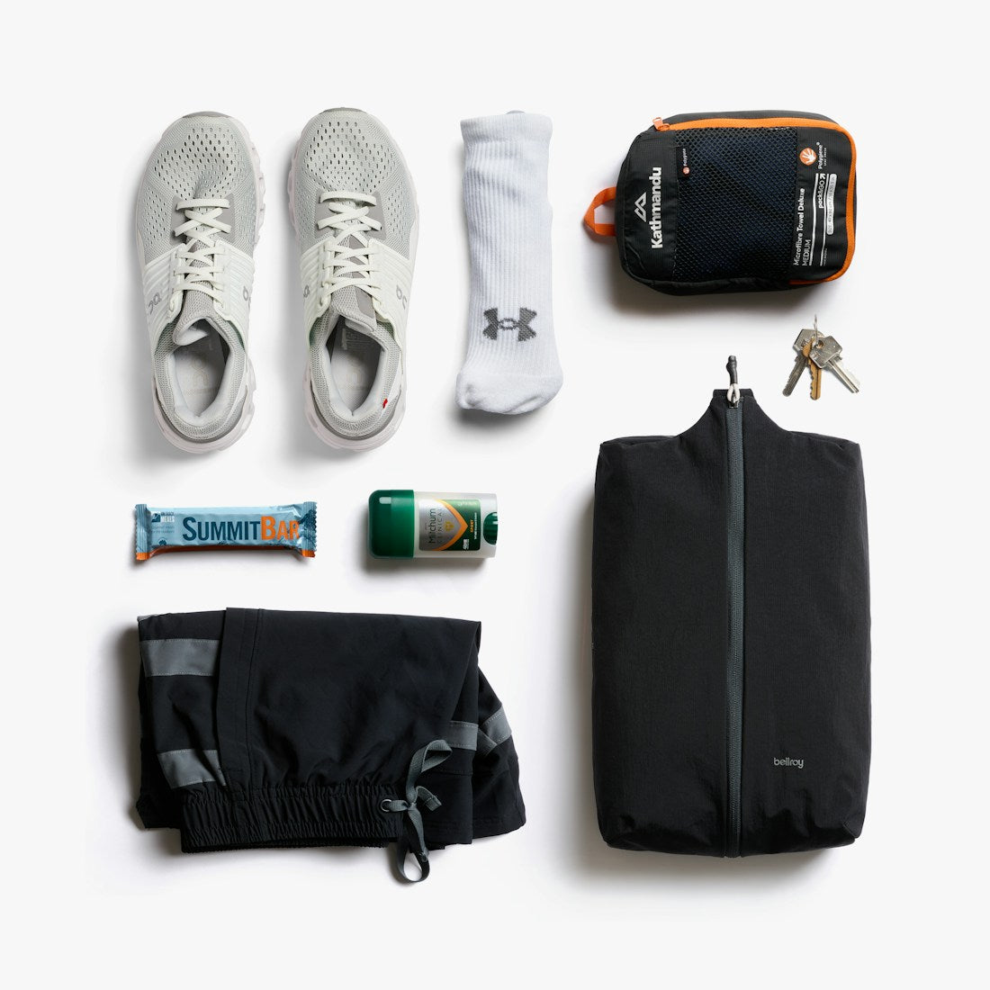Bellroy Lite Packing Caddy 10L in Black, flat lay with sneakers and travel items - The Simple Man
