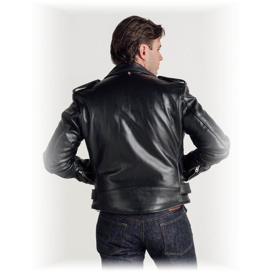 Back view on model of the black steerhide Perfecto motorcycle jacket with bi-swing back - The Simple Man