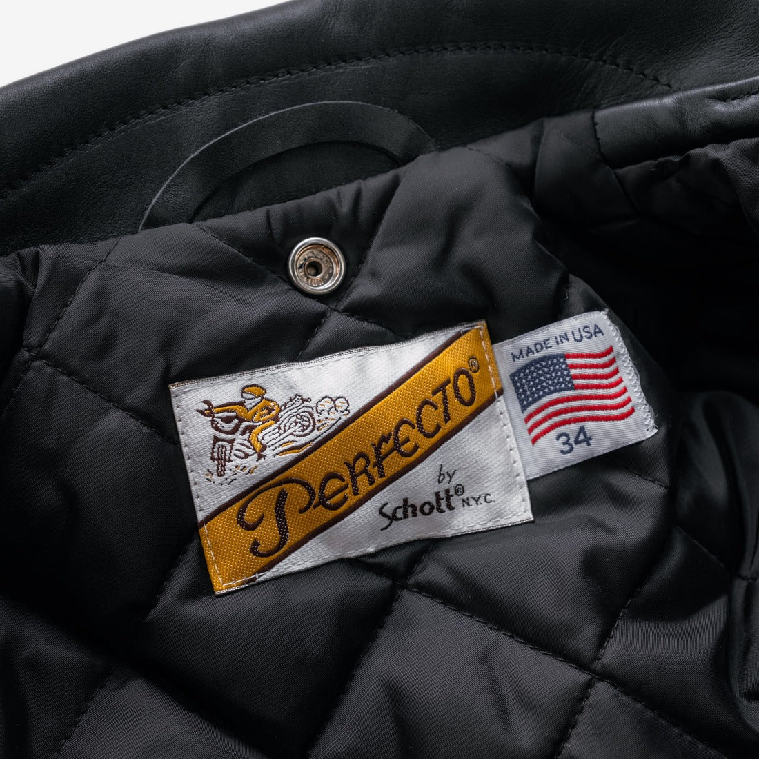 Inside of the black Perfecto jacket showing the Made in USA label and quilted nylon lining - The Simple Man