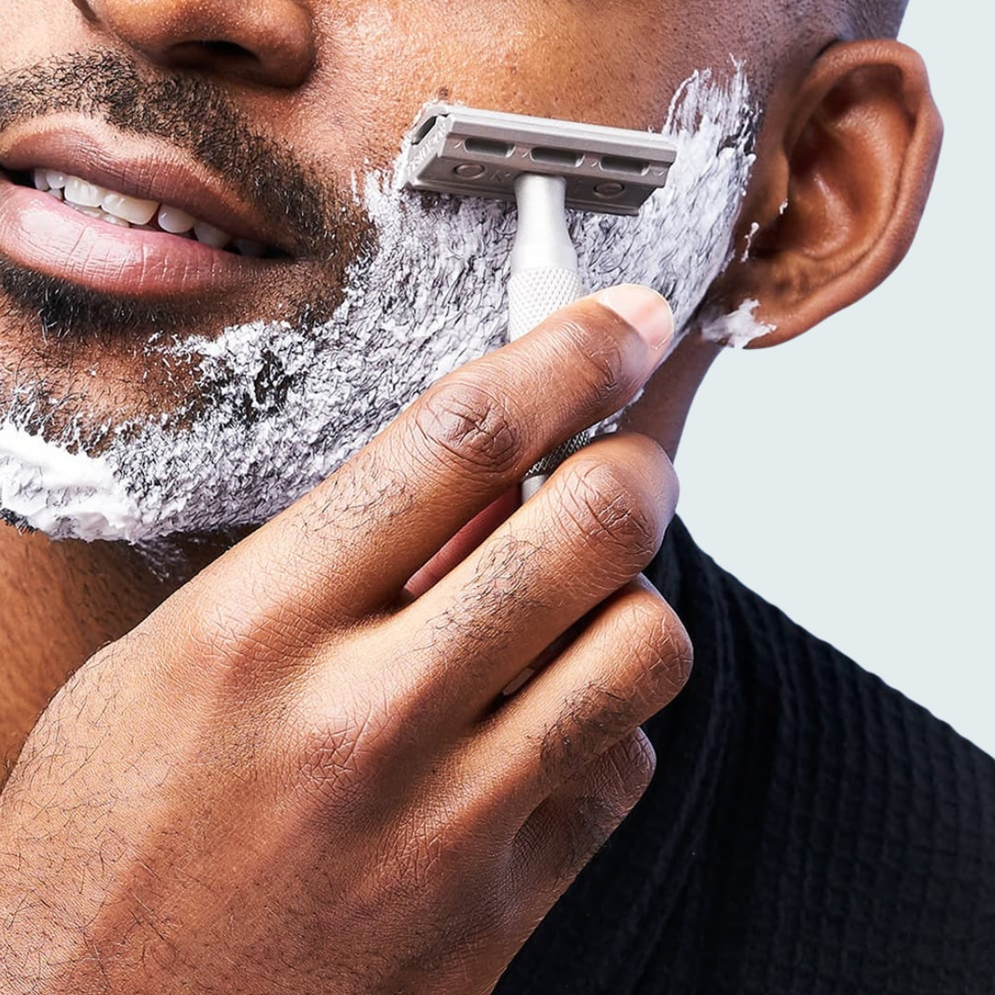 Man with shaving cream on his jaw using a 6S safety razor, lifestyle shot