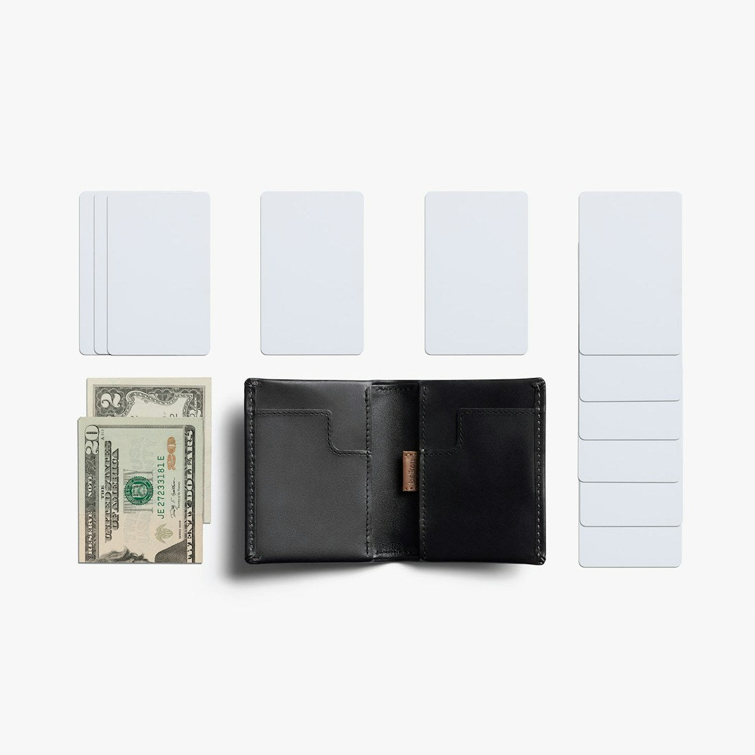 Bellroy Slim Sleeve wallet in Black, flat lay with cards and a bill - The Simple Man