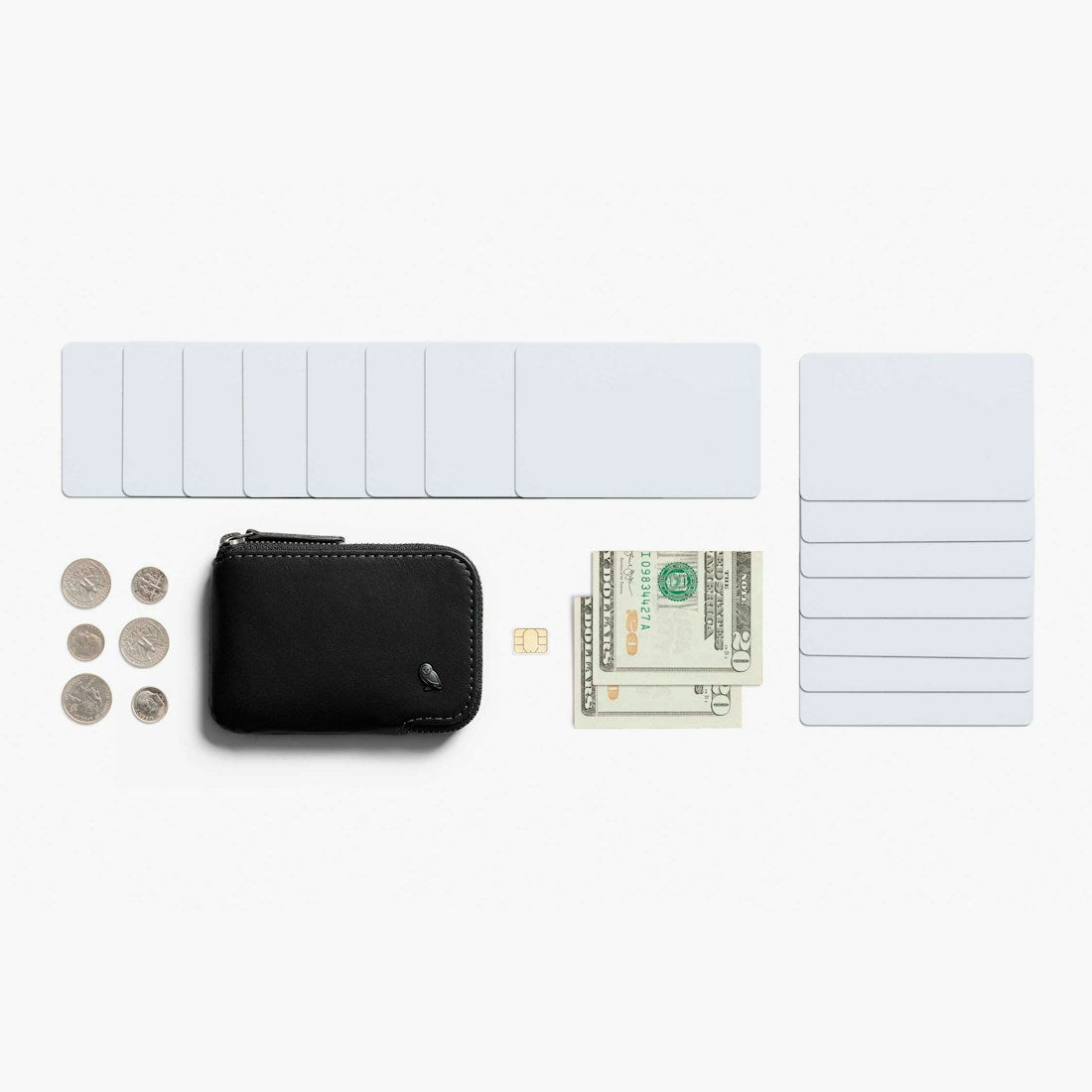 Bellroy Card Pocket wallet in Black, flat lay with cards, cash and a SIM card - The Simple Man