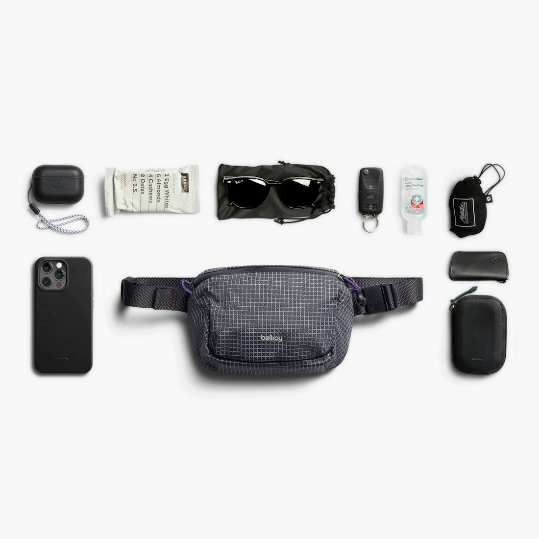Bellroy Lite Belt Bag in Arcade Grey, flat lay of everyday items with the belt bag - The Simple Man