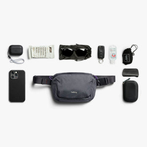 Bellroy Lite Belt Bag in Arcade Grey, flat lay of everyday items with the belt bag - The Simple Man
