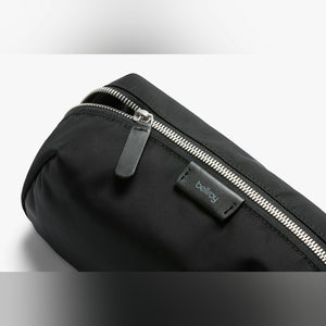 Bellroy Toiletry Kit Plus travel toiletry bag in Black, close-up of black fabric and leather zipper pull - The Simple Man