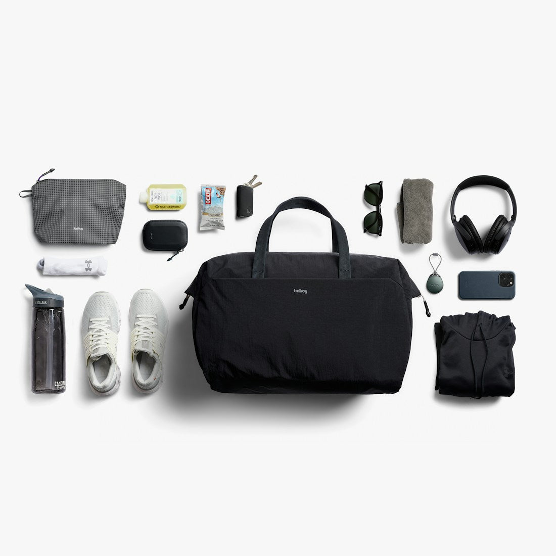 Bellroy Lite Duffel in Black, flat lay of travel items around the duffel - The Simple Man
