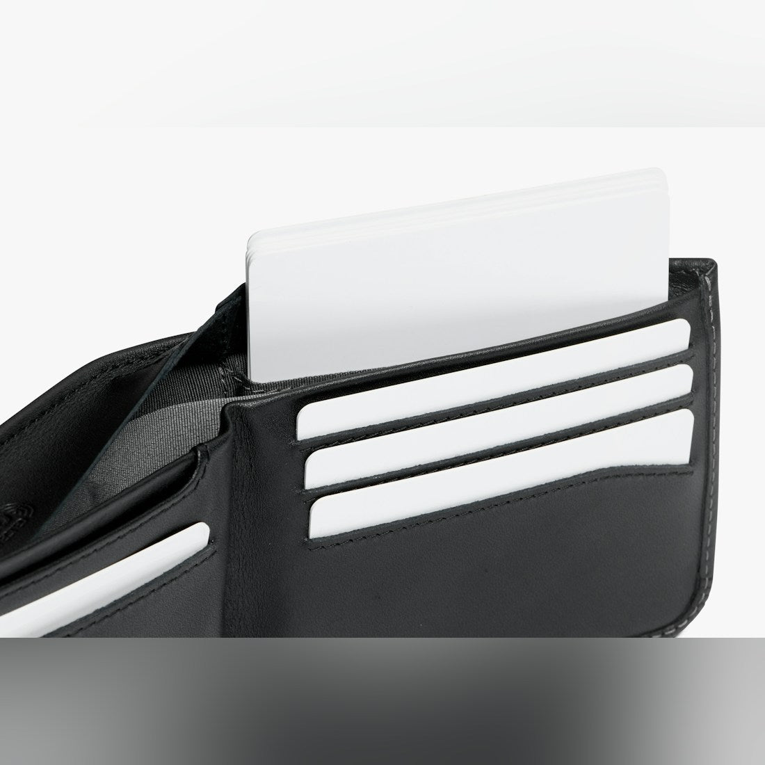 Bellroy Hide & Seek RFID leather wallet in Black, close-up of card slots with a card pulled up - The Simple Man