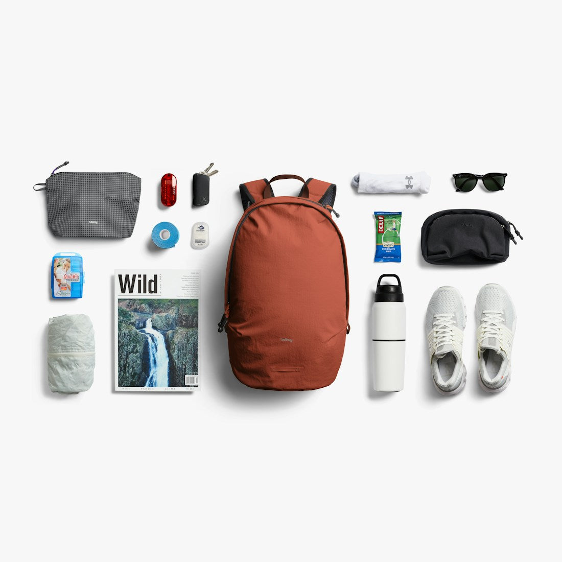 Bellroy Lite Daypack in Clay, flat lay of everyday items with the daypack - The Simple Man