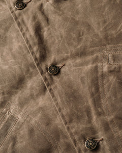 Close-up of the metal shank button front on the brown waxed cotton mechanic jacket - The Simple Man