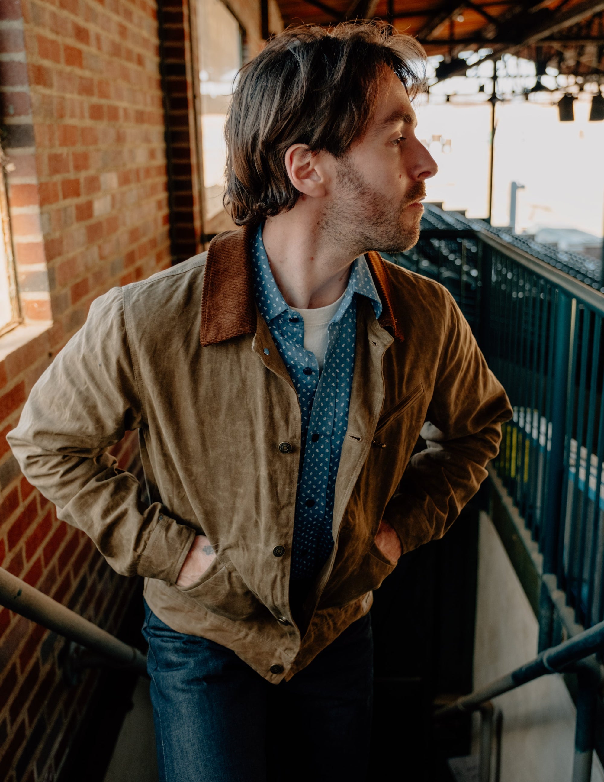 Side view on model of the brown waxed cotton mechanic jacket with corduroy collar - The Simple Man