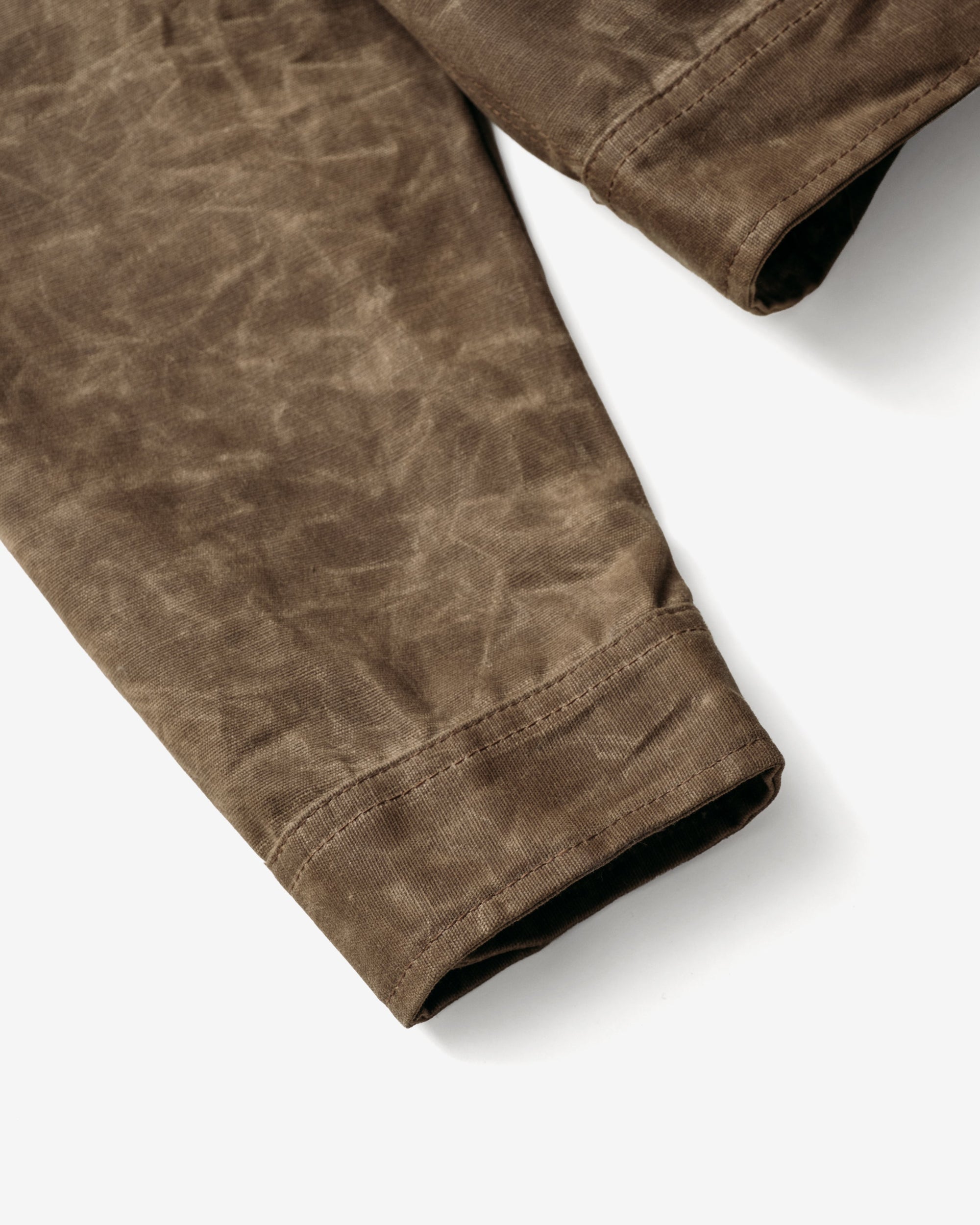 Close-up of the sleeve cuff on the brown waxed cotton mechanic jacket - The Simple Man