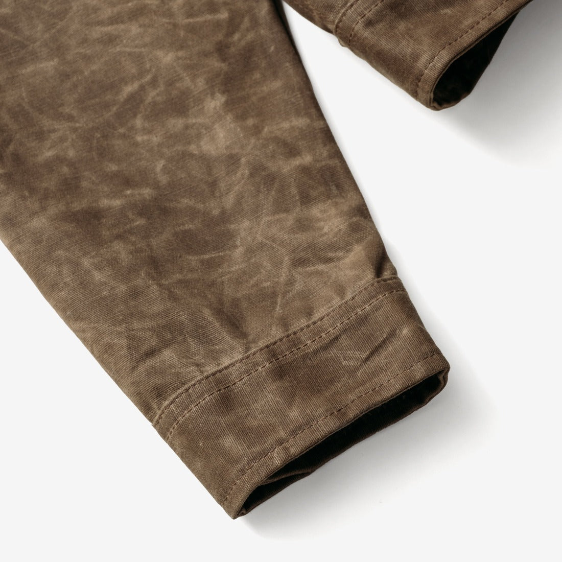 Close-up of the sleeve cuff on the brown waxed cotton mechanic jacket - The Simple Man