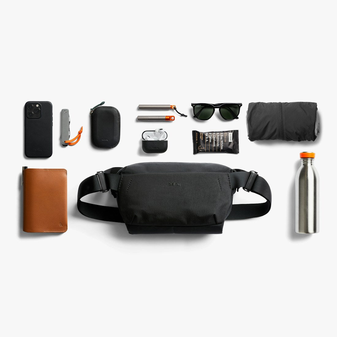 Bellroy Venture Sling 6L in Black, flat lay with everyday items - The Simple Man
