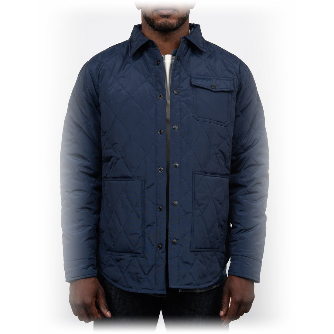 Man wearing the navy down filled quilted shirt jacket over a white tee, front view on model - The Simple Man
