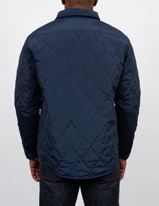 Back view on model of the navy quilted shirt jacket - The Simple Man