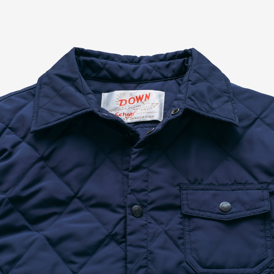 Close-up of the collar, snap placket and chest pocket on the navy quilted shirt jacket - The Simple Man