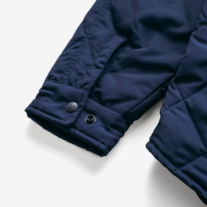Close-up of the snap cuff on the navy quilted shirt jacket sleeve - The Simple Man