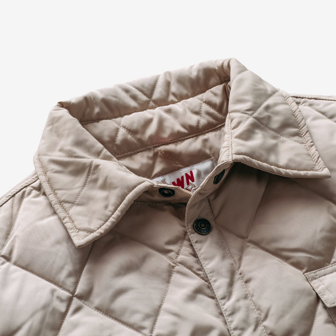 Close-up of the collar and snap front on the off white quilted shirt jacket - The Simple Man