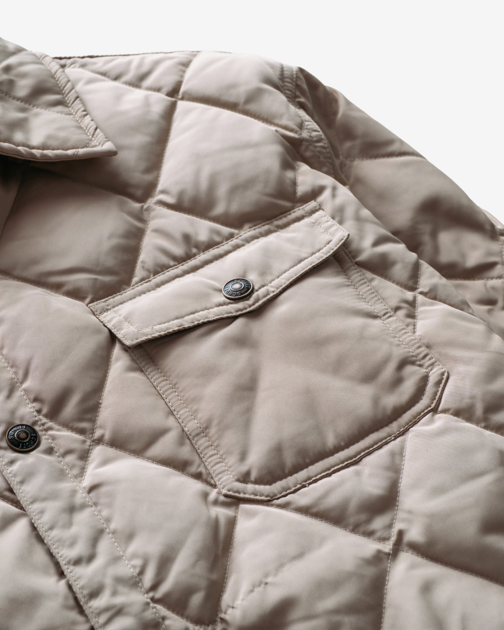 Close-up of the snap chest patch pocket on the off white quilted shirt jacket - The Simple Man