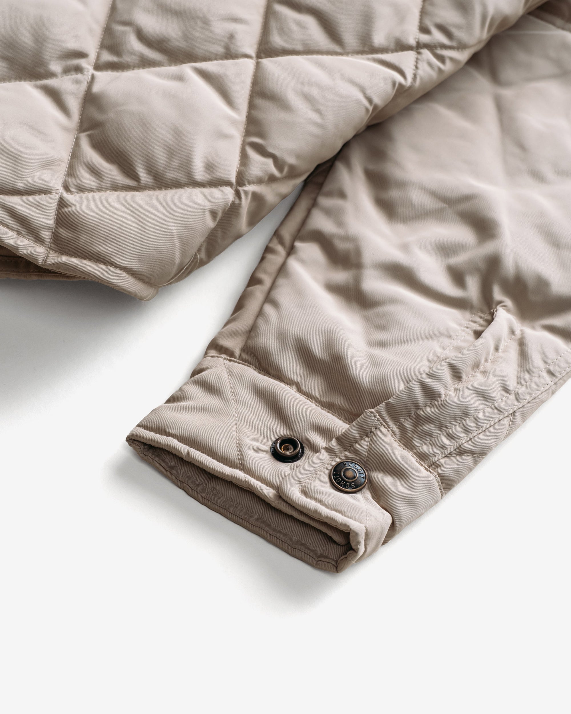 Close-up of the snap cuff on the off white quilted shirt jacket sleeve - The Simple Man