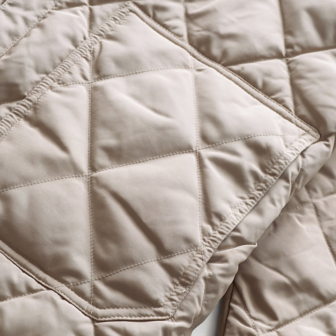 Close-up of the diamond quilting and lower patch pocket on the off white quilted shirt jacket - The Simple Man