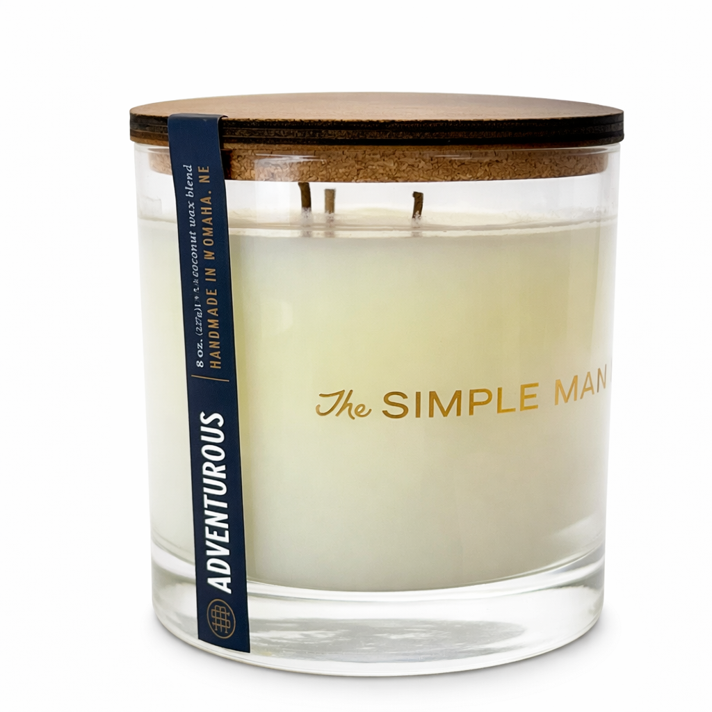 Candle with wooden lid and 'The Simple Man' branding on a white background -Adventurous Close up