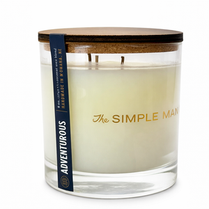 Candle with wooden lid and 'The Simple Man' branding on a white background -Adventurous Close up