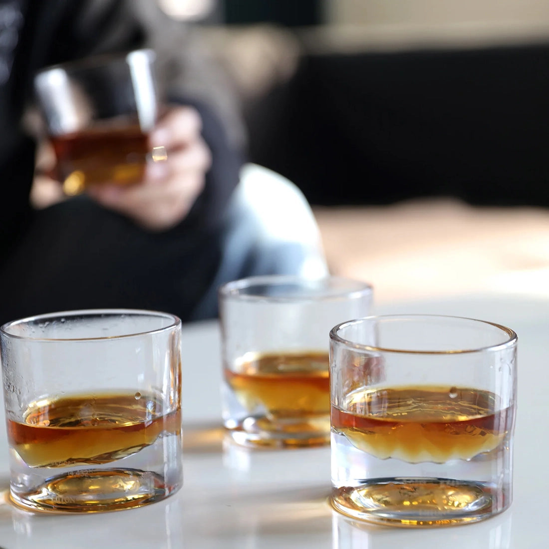 Mountain base whiskey glasses chilling bourbon without ice on a modern coffee table