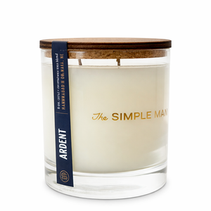 Candle with wooden lid and 'The Simple Man' branding on a white background. -Ardent