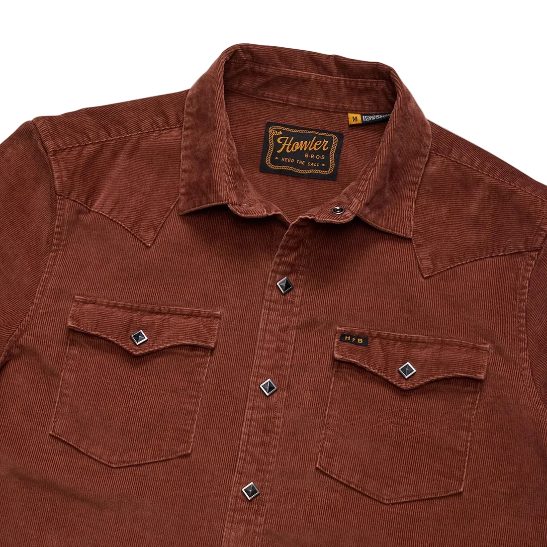 Close-up of diamond pearl snap buttons and chest pockets on the Mink Brown Banning Corduroy Snapshirt showing the Howler Bros label -- The Simple Man