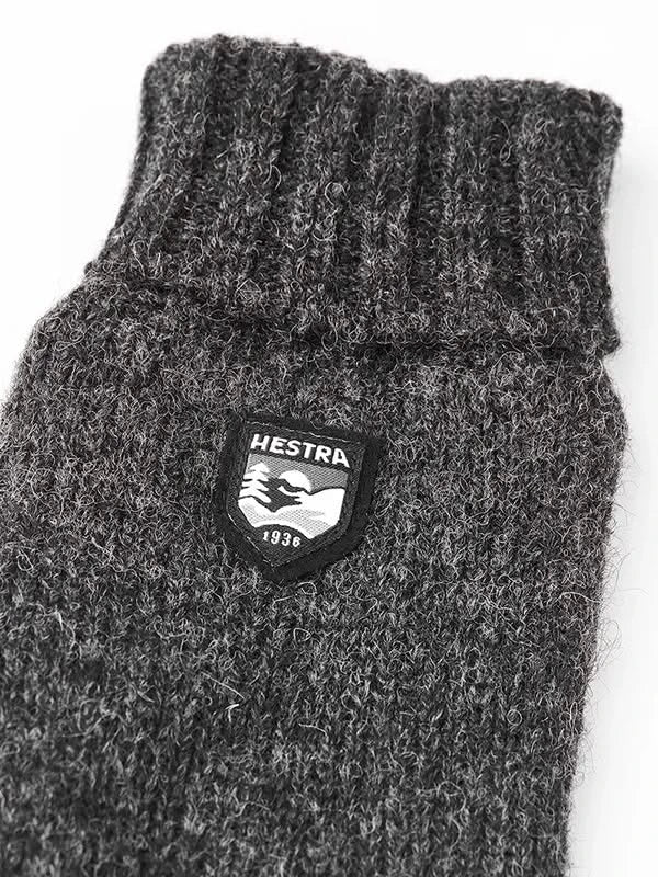 Close-up of Hestra Basic Wool Gloves in charcoal — rib-knit cuff and Shetland wool texture, photographed at The Simple Man Omaha