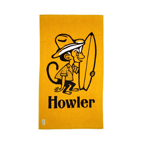 Howler Bros El Mono beach towel flat lay dijon yellow – surfing monkey graphic 100% cotton oversized 34x60 inch beach towel Howler Paradise label