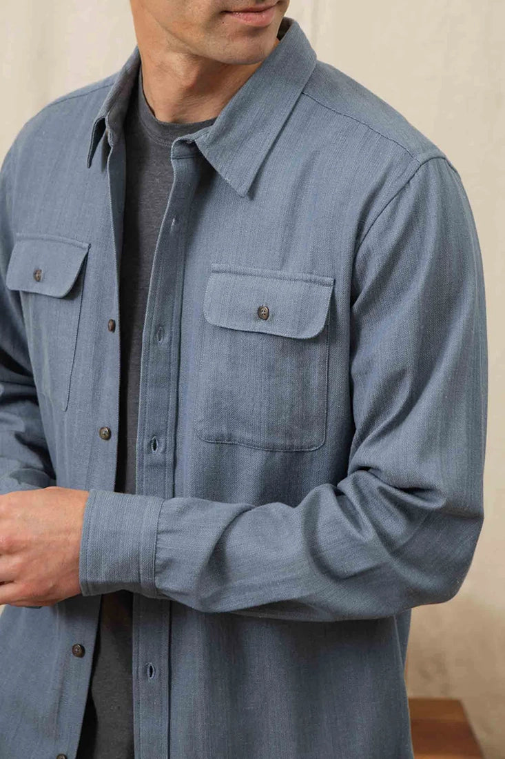 Side profile of man wearing Bedford Shirt in denim herringbone cotton.