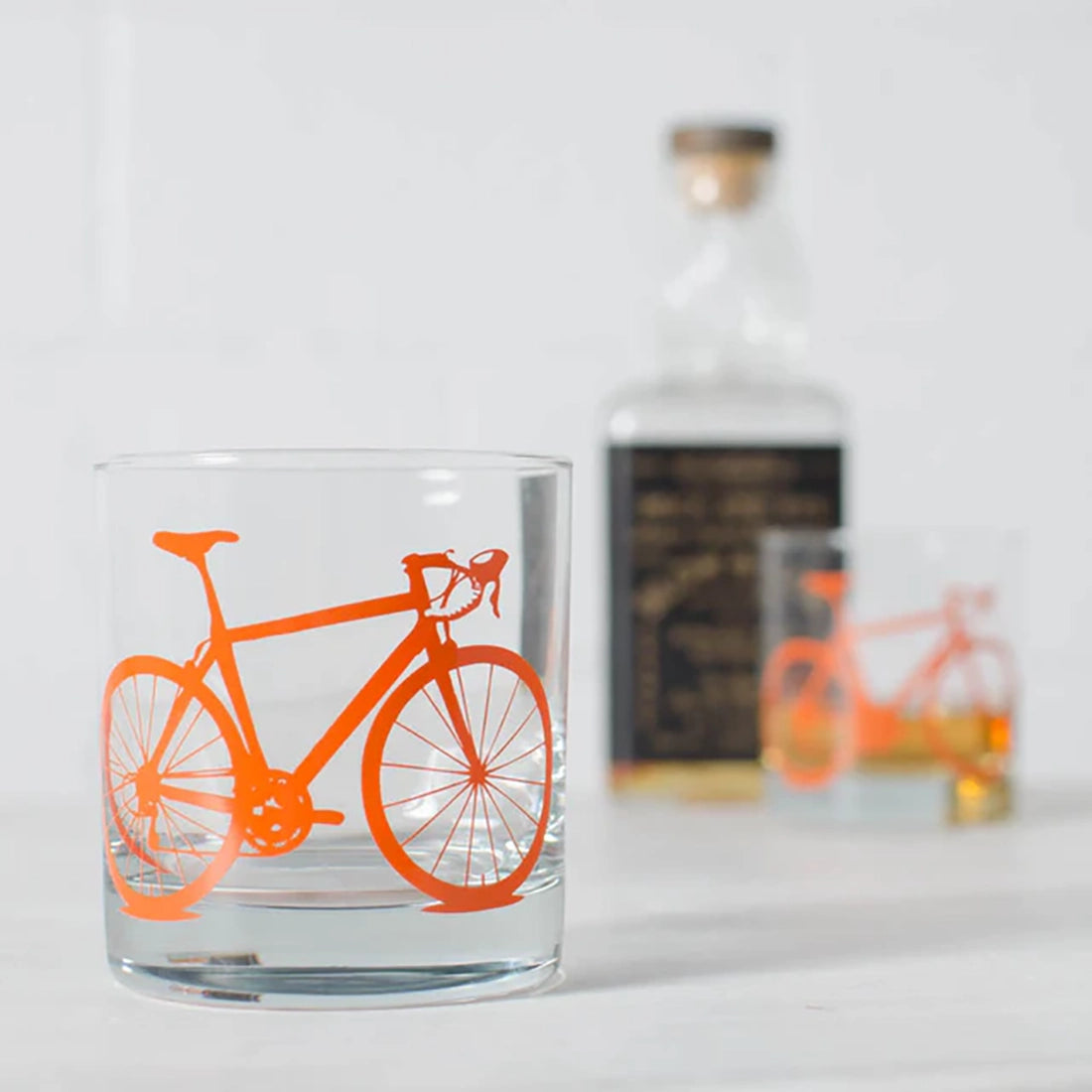 Bicycle rocks glass in orange with road bike graphic – 11oz screen printed whiskey glass – The Simple Man
